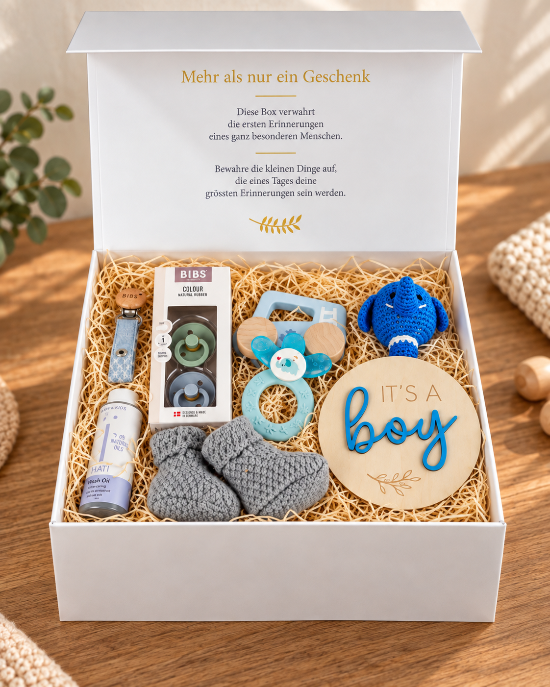 Open baby gift box Raphael with elephant rattle, gray baby shoes, BIBS pacifier pack of 2, pacifier chain, cooling teething ring, wooden car and NAÏF washing oil