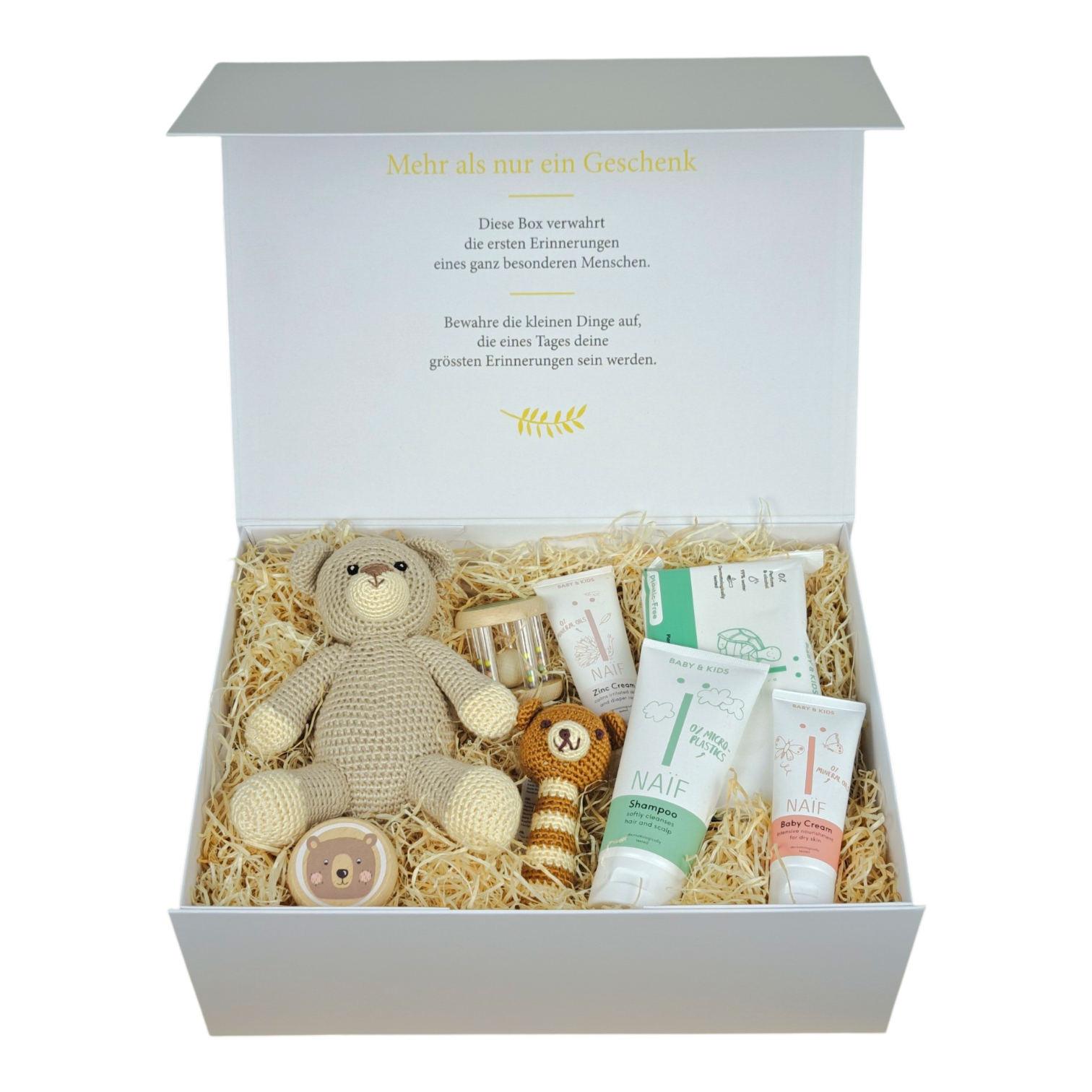 Bruno gift box for babies with a crocheted bear, baby rattle, grasping toy, Pampers Premium Protection size 2 and NAÏF care products in a cream white magnetic box.