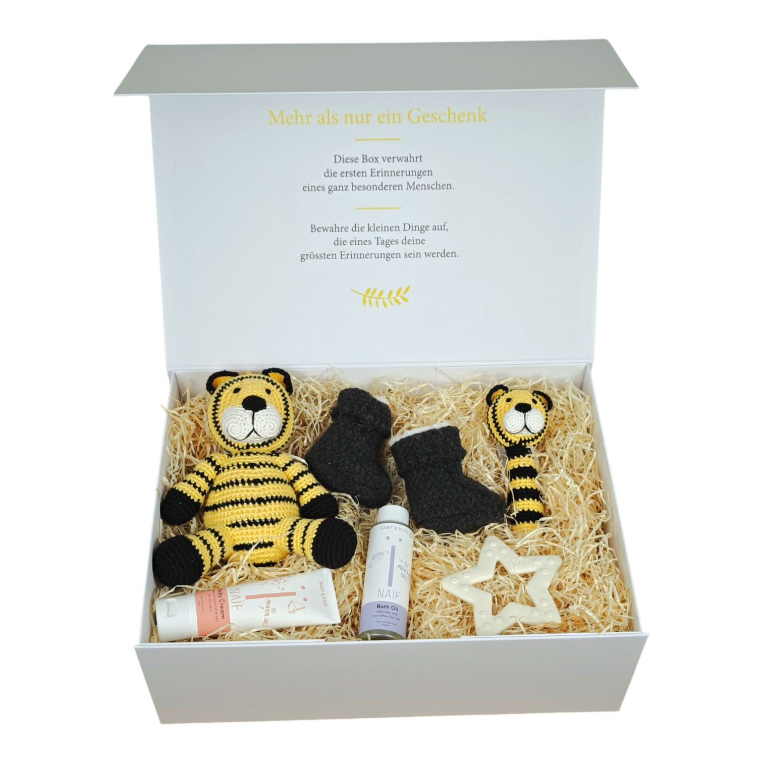 Leandro gift box for babies with a crocheted tiger, matching baby rattle, knitted baby shoes, BIBS teething ring star, NAÏF bath oil and baby cream in a cream white magnetic box.