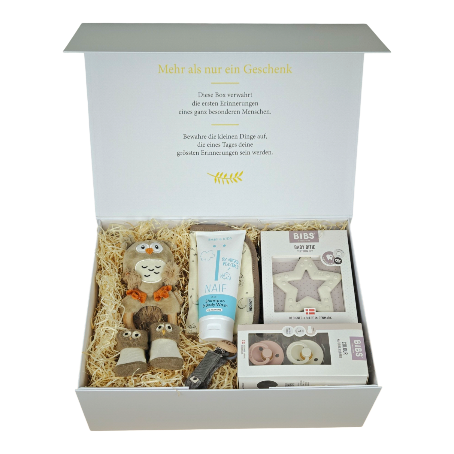 Lio gift box for babies in beige, brown and gray with owl rattle, bib, baby socks, BIBS pacifiers, pacifier chain, teething ring star and NAÏF 2in1 shampoo & shower gel in a cream white magnetic box.