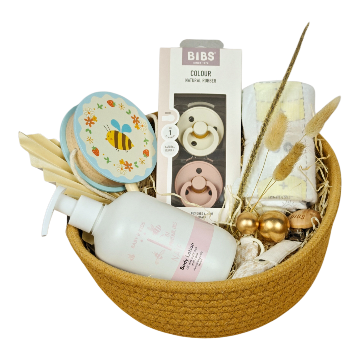 June gift basket with rotating drum bee, BIBS pacifiers, pacifier chain, NAÏF body lotion and Pampers diaper rolls