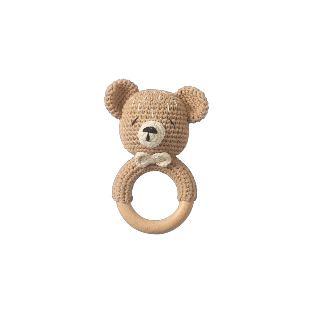 Die Windeltorte Bärencamp [42x25cm] von Hello World zeigt eine beige gehäkelte Teddybär-Rassel mit Fliege auf einem Holzring, zentriert auf weiß - perfekt als Babygeschenk oder liebevolles Geschenk zur Geburt.