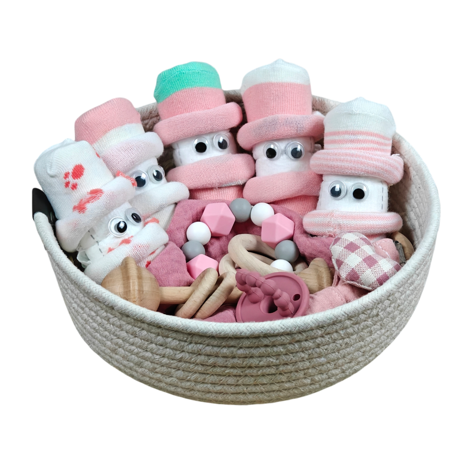 Das Hello World Kuschelkörbchen Blütenfünflinge besteht aus gerollten Babysöckchen mit Glotzaugen als niedliche Figuren, dazu rosa und hölzernes Babyspielzeug und natürliche Beißperlen.